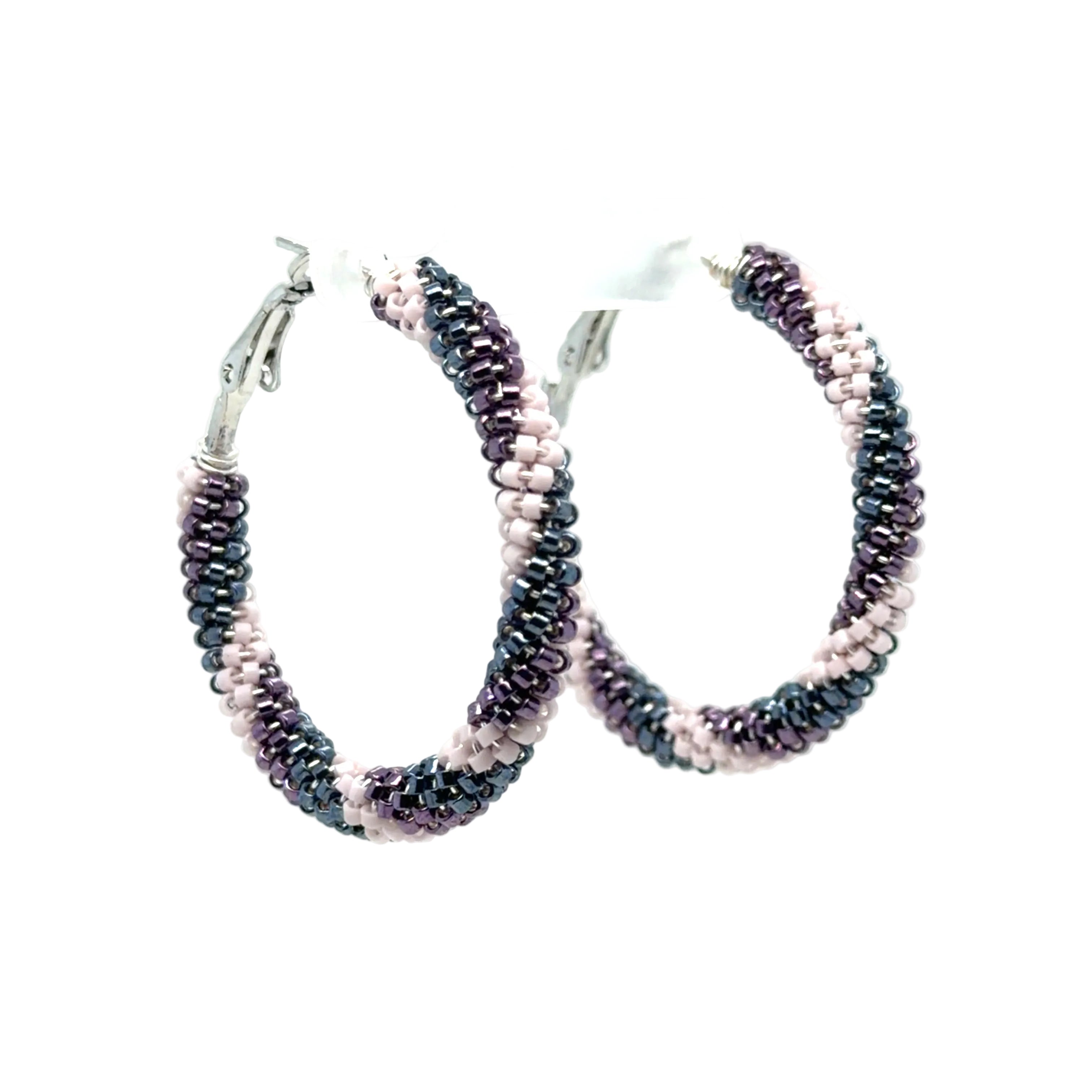 A pair of medium hoop earrings made from small seed beads in a dark metallic gray, black, and light pink gradient, with silver-toned fishhook closures, shown on a plain white background.