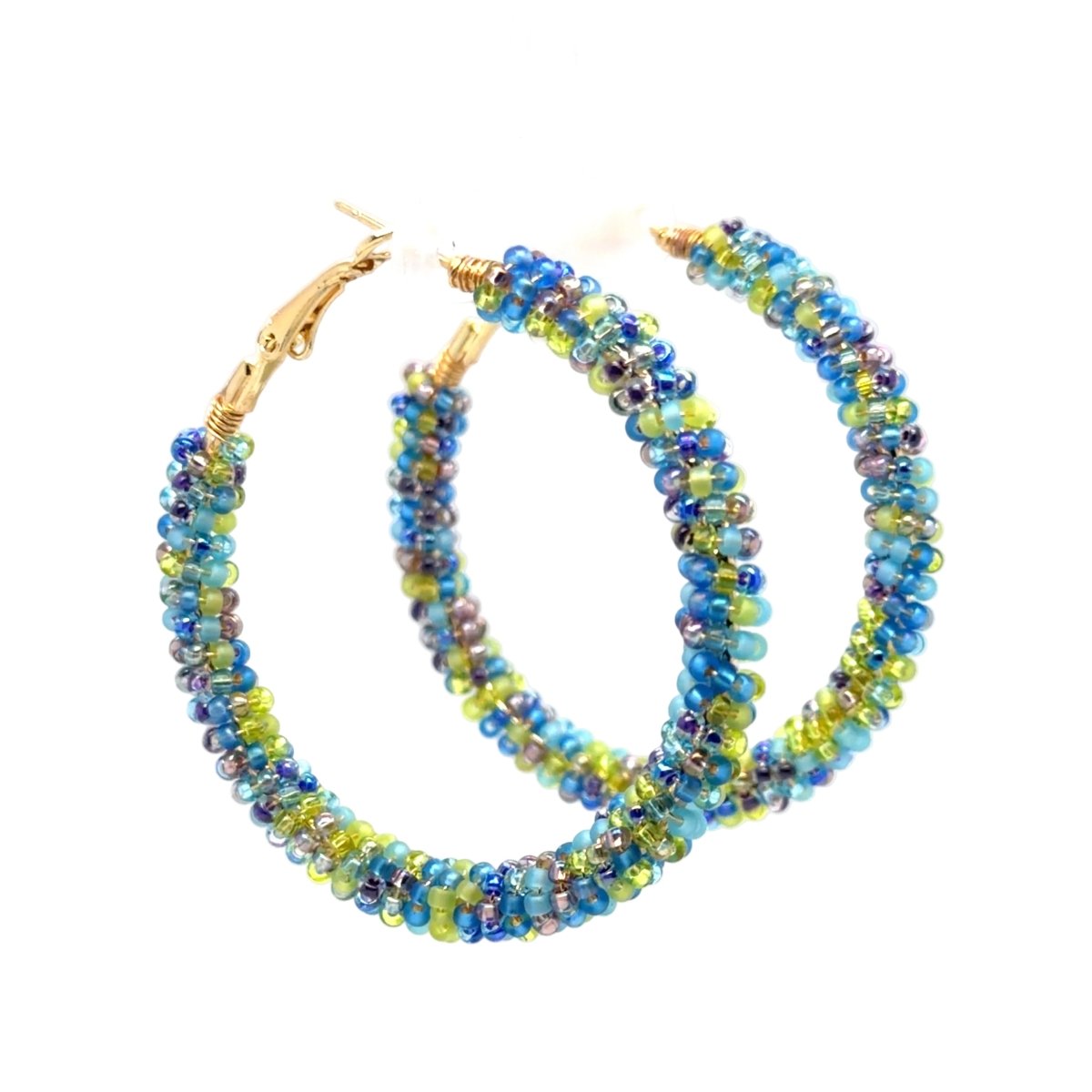 A pair of handmade beaded hoop earrings with gold-tone clasp backs. The hoops are composed of small, iridescent beads that shift between blue, green, and purple, wrapped with gold-tone wire at the top.