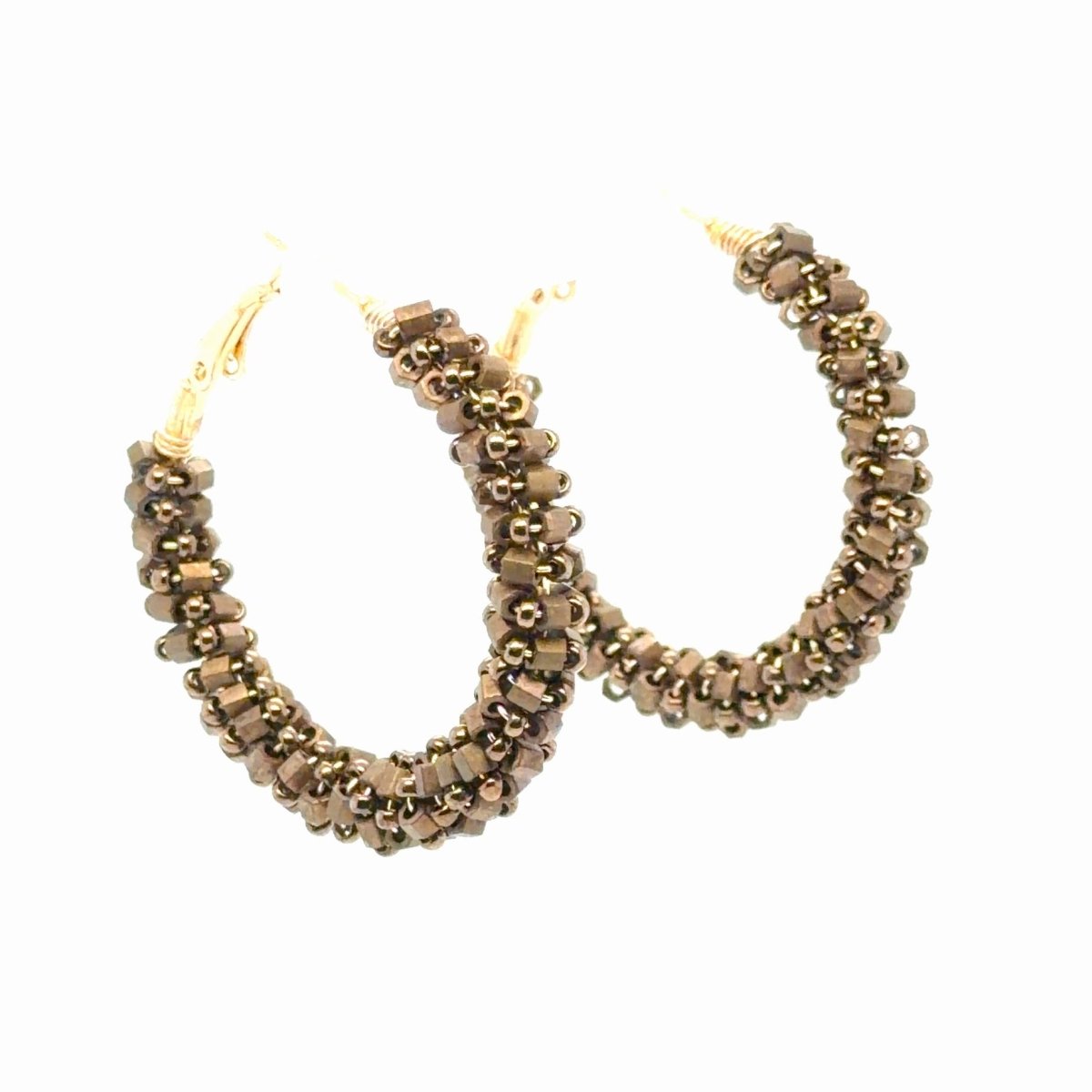 A pair of large gold hoop earrings embellished with multiple rows of small brown and gold faceted beads, shown against a plain white background.