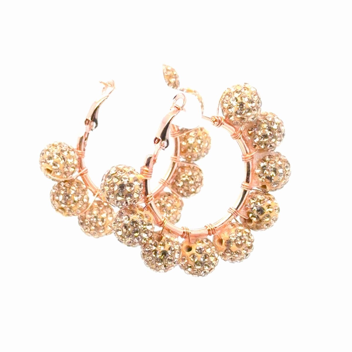 Rose gold hoop earrings adorned with multiple round, crystal-encrusted beads, displayed on a clean white background.