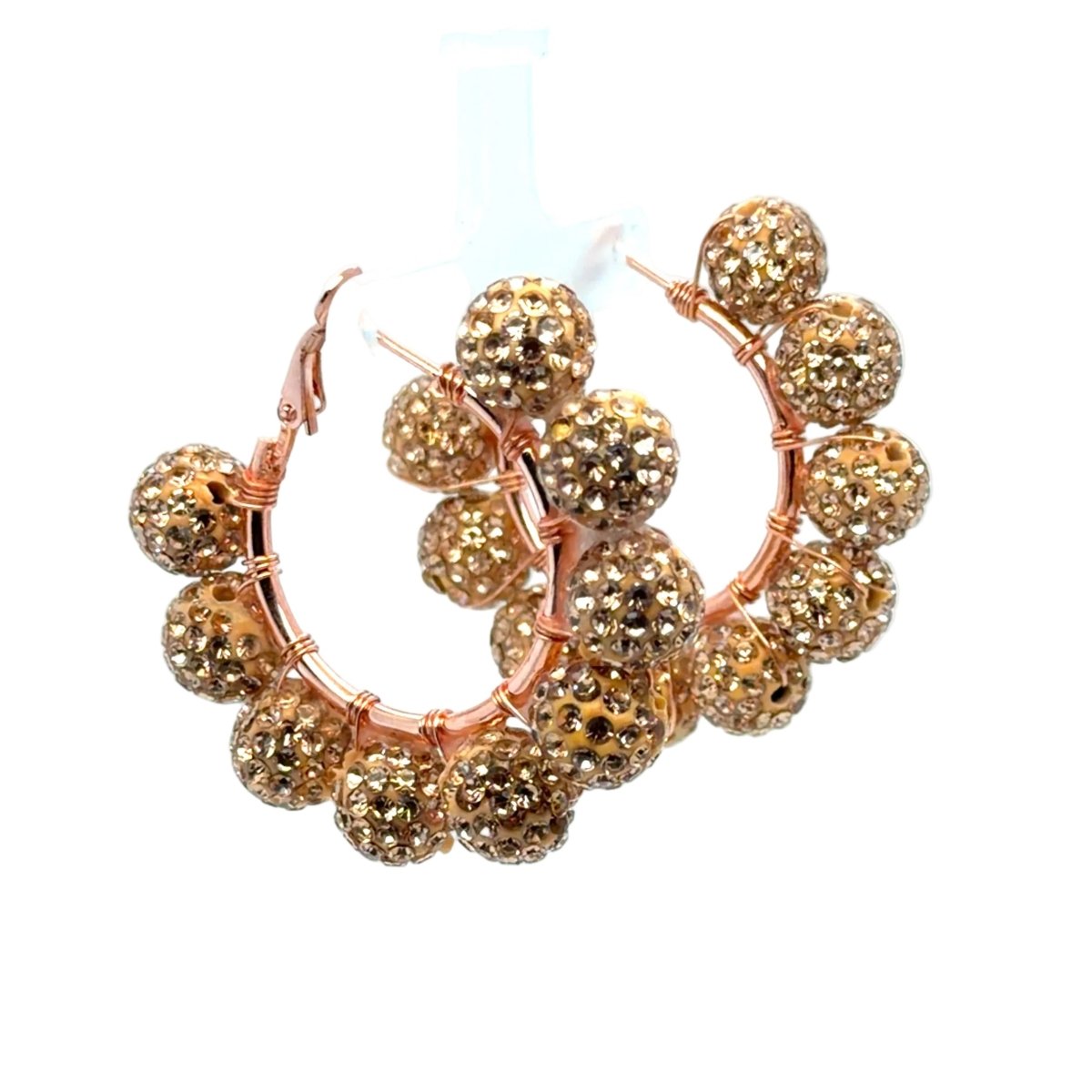 Rose gold hoop earrings adorned with multiple textured, faceted gold beads, displayed on a clean white background.