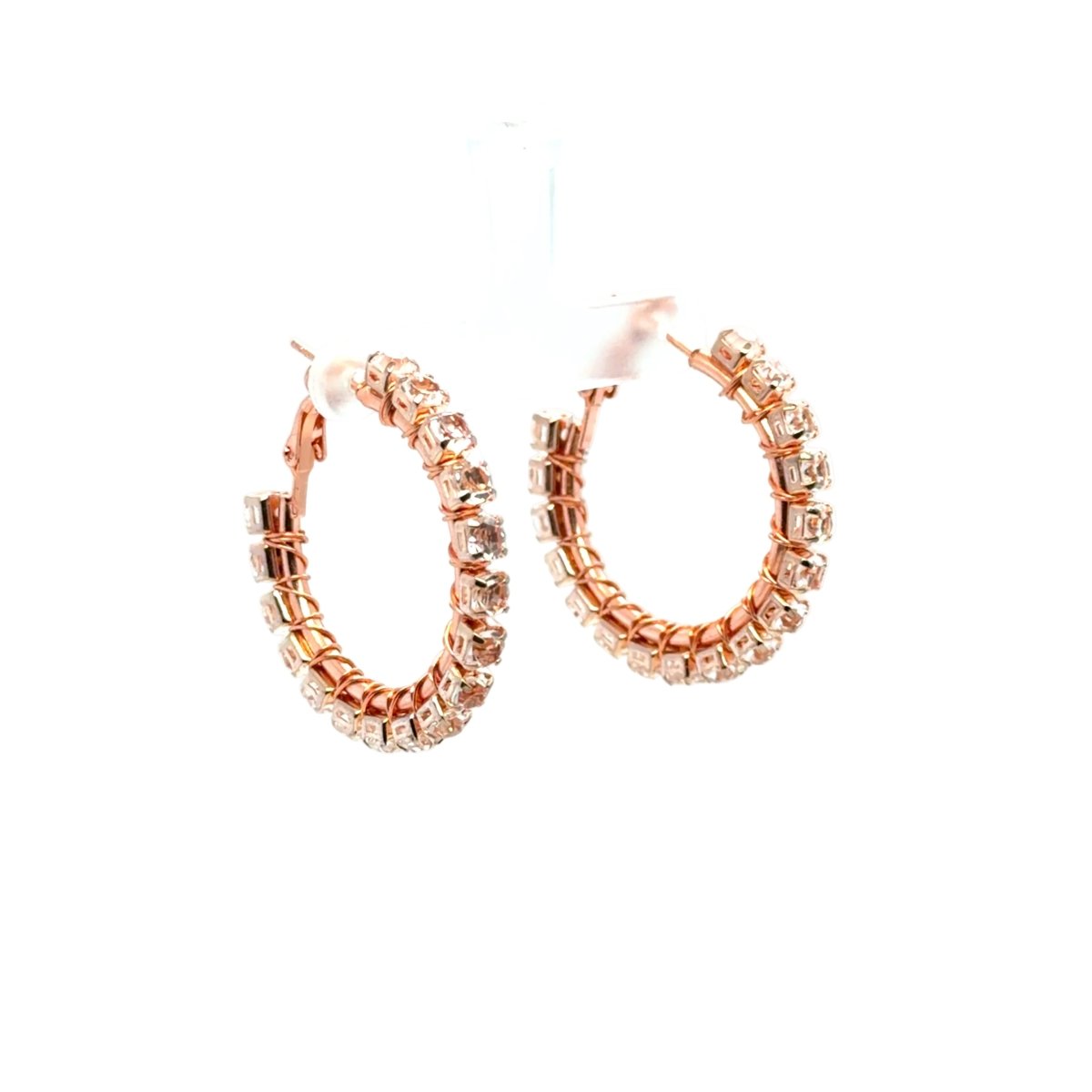 Rose gold hoop earrings adorned with clear rhinestones, displayed on a white background.
