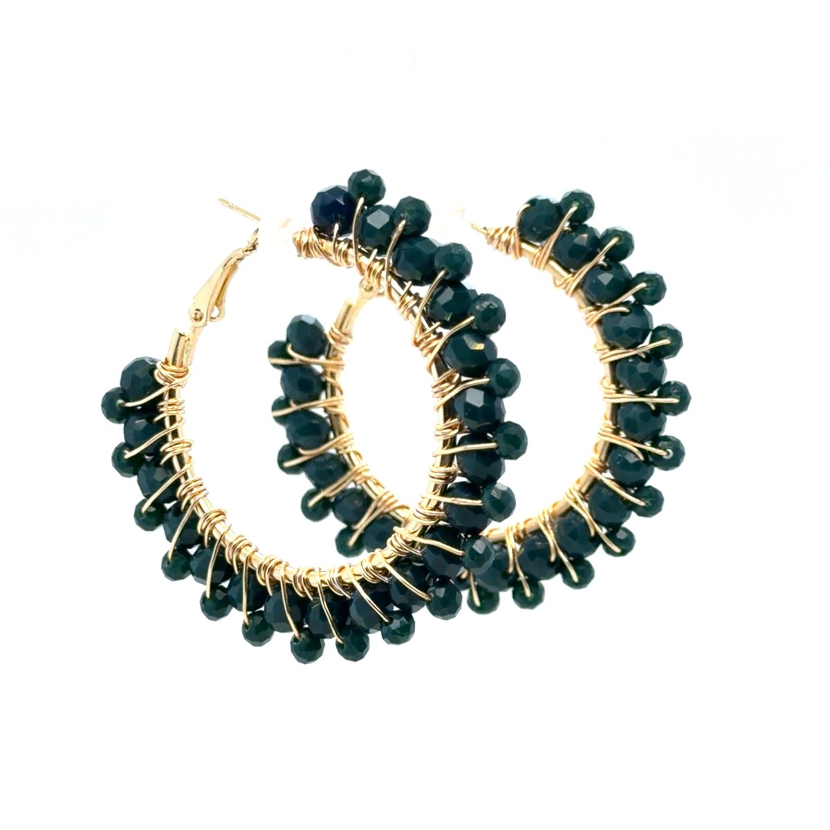 A pair of gold hoop earrings wrapped with small faceted dark green beads, shown on a plain white background.