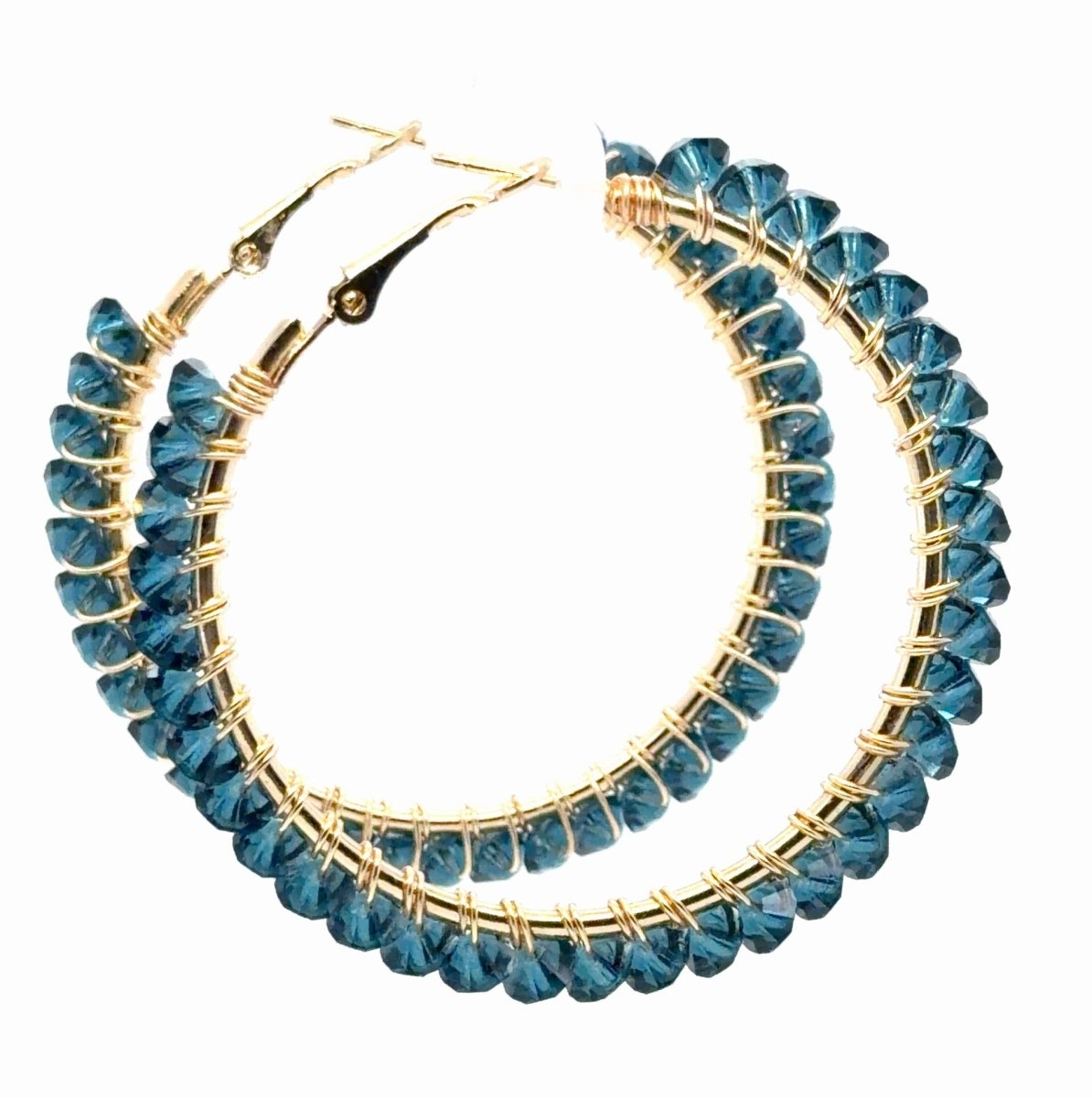A pair of gold hoop earrings adorned with multiple strands of faceted blue beads, shown against a plain white background.