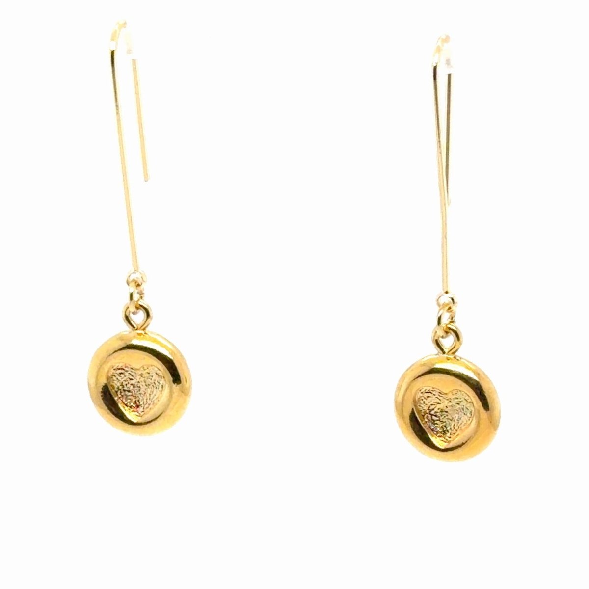 A pair of gold drop earrings with round disc charms featuring a textured heart design, suspended from thin fishhook wires on a plain white background.