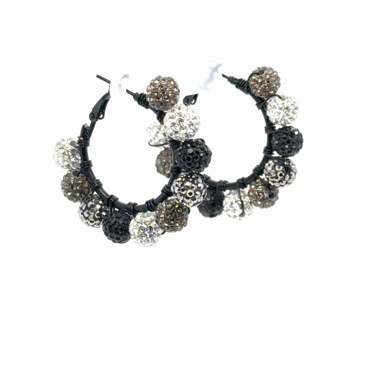 Angled view of Maeven in Me silver, black, and smoky taupe rhinestone ball hoops with black wire wrapping.
