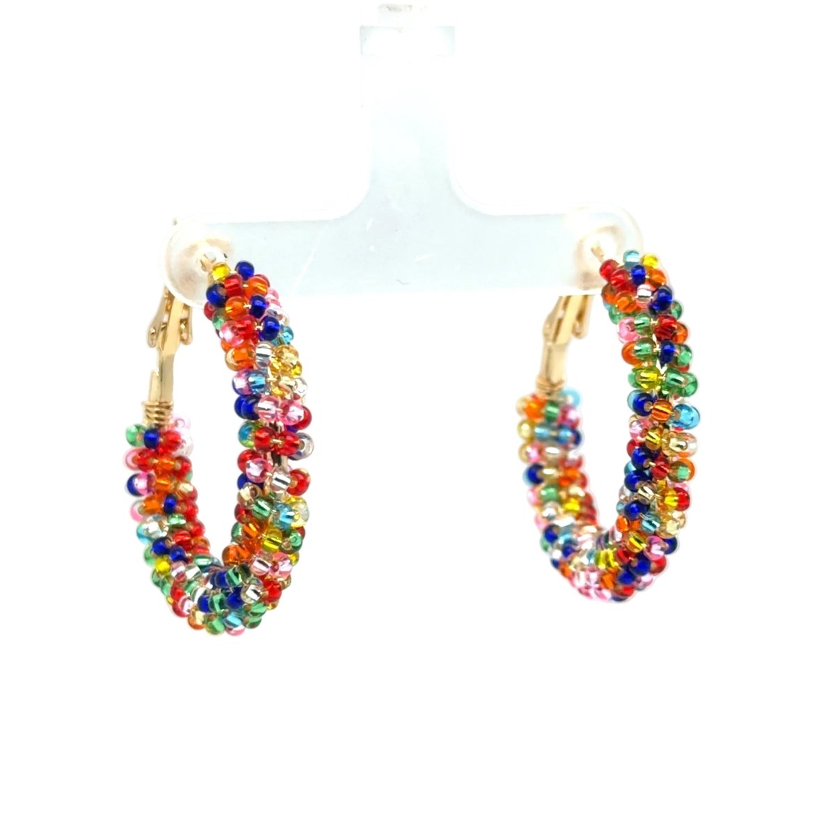 A pair of gold hoop earrings wrapped with multicolored faceted beads, displayed on a clear plastic stand against a white background.