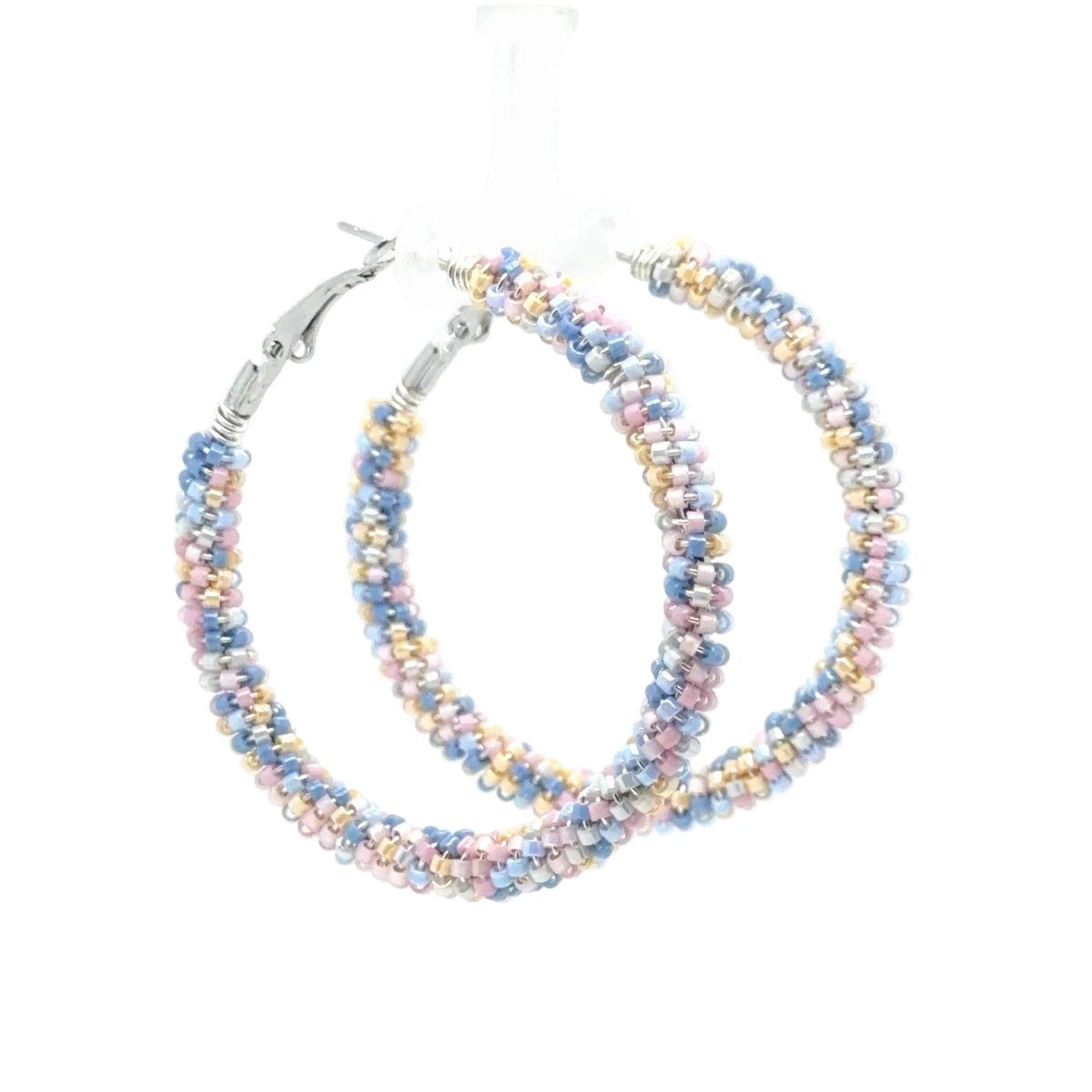 A pair of large hoop earrings made from tightly woven small beads in pastel blue, pink, lavender, and gold, with silver-tone clasp closures, shown on a white background.