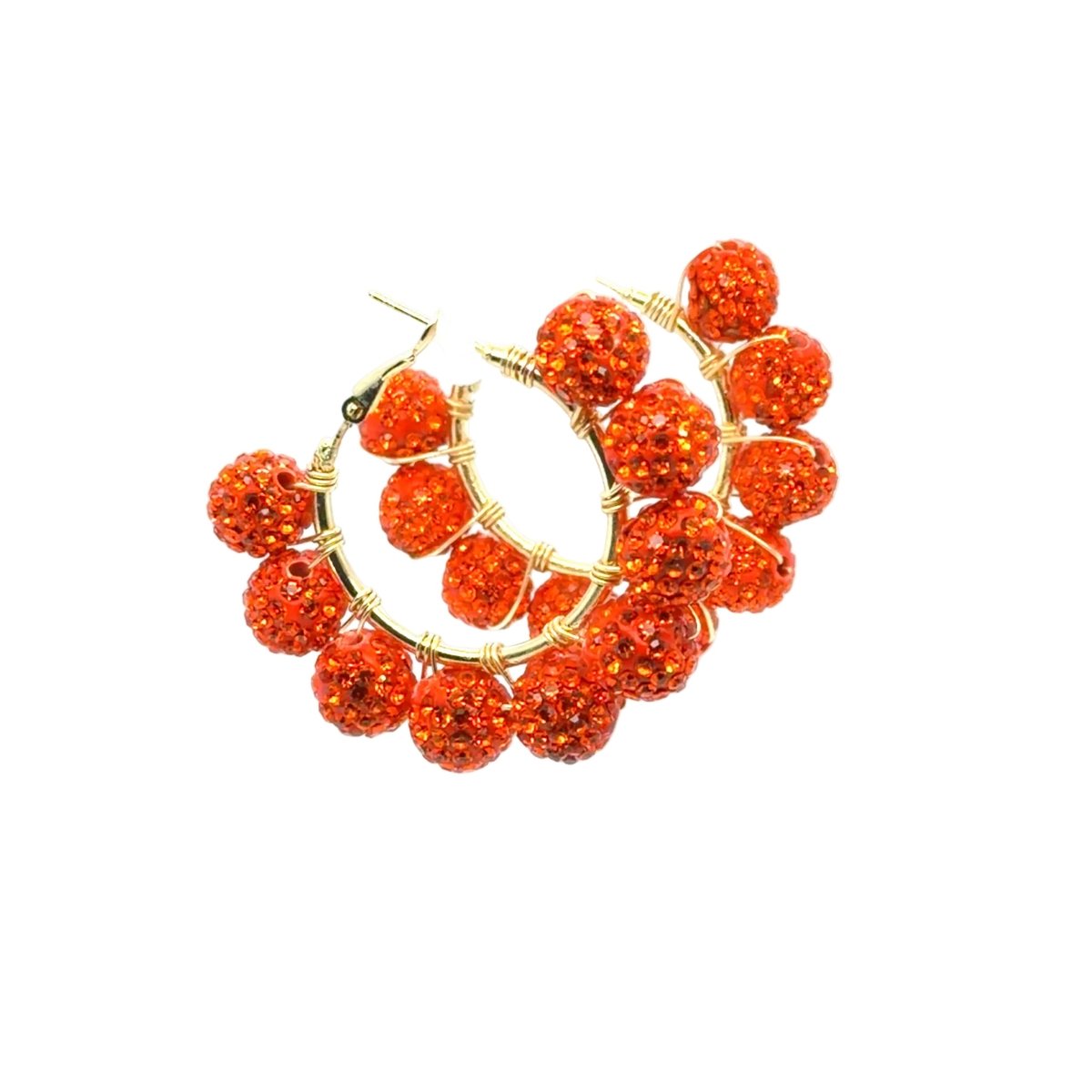 A pair of gold hoop earrings adorned with multiple textured, orange-red glittery beads, shown on a plain white background.