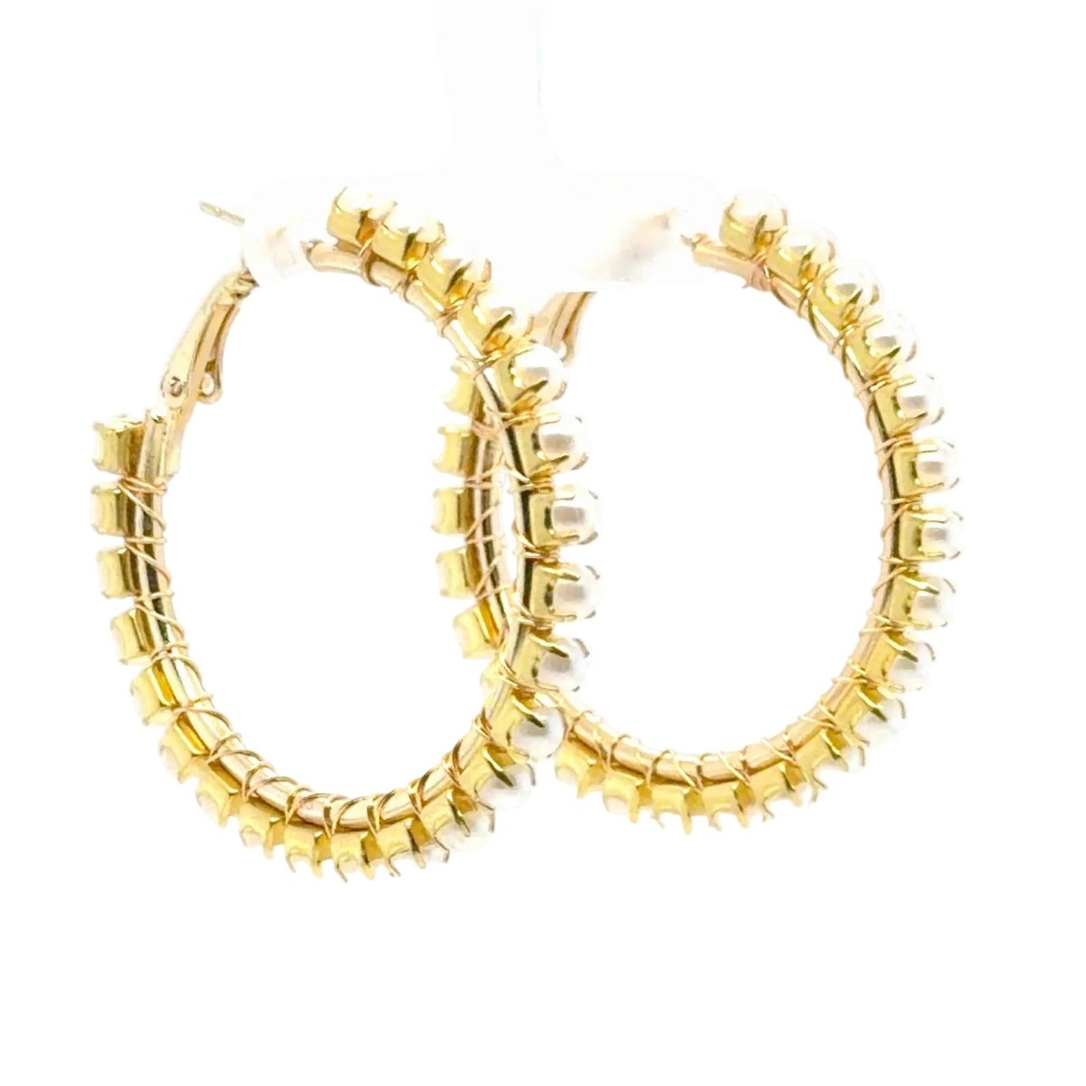 A pair of gold hoop earrings with a textured, beaded outer edge, displayed on a clean white background.