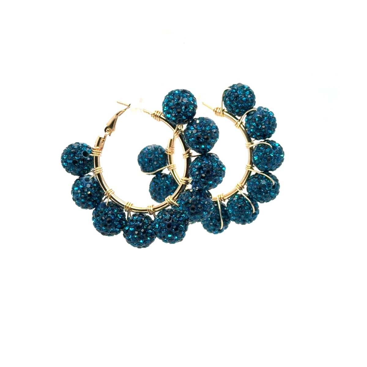 Maeven in Me gold-tone hoop earrings with teal-blue rhinestone beads on a white background.